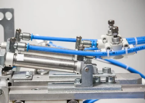 Air cylinders with push-to-connect fittings and blue tubing