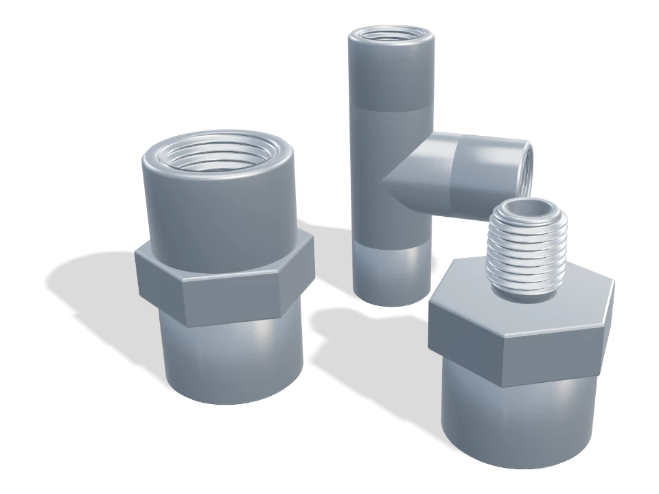 Machined stainless thread adapters and a tee on a white background